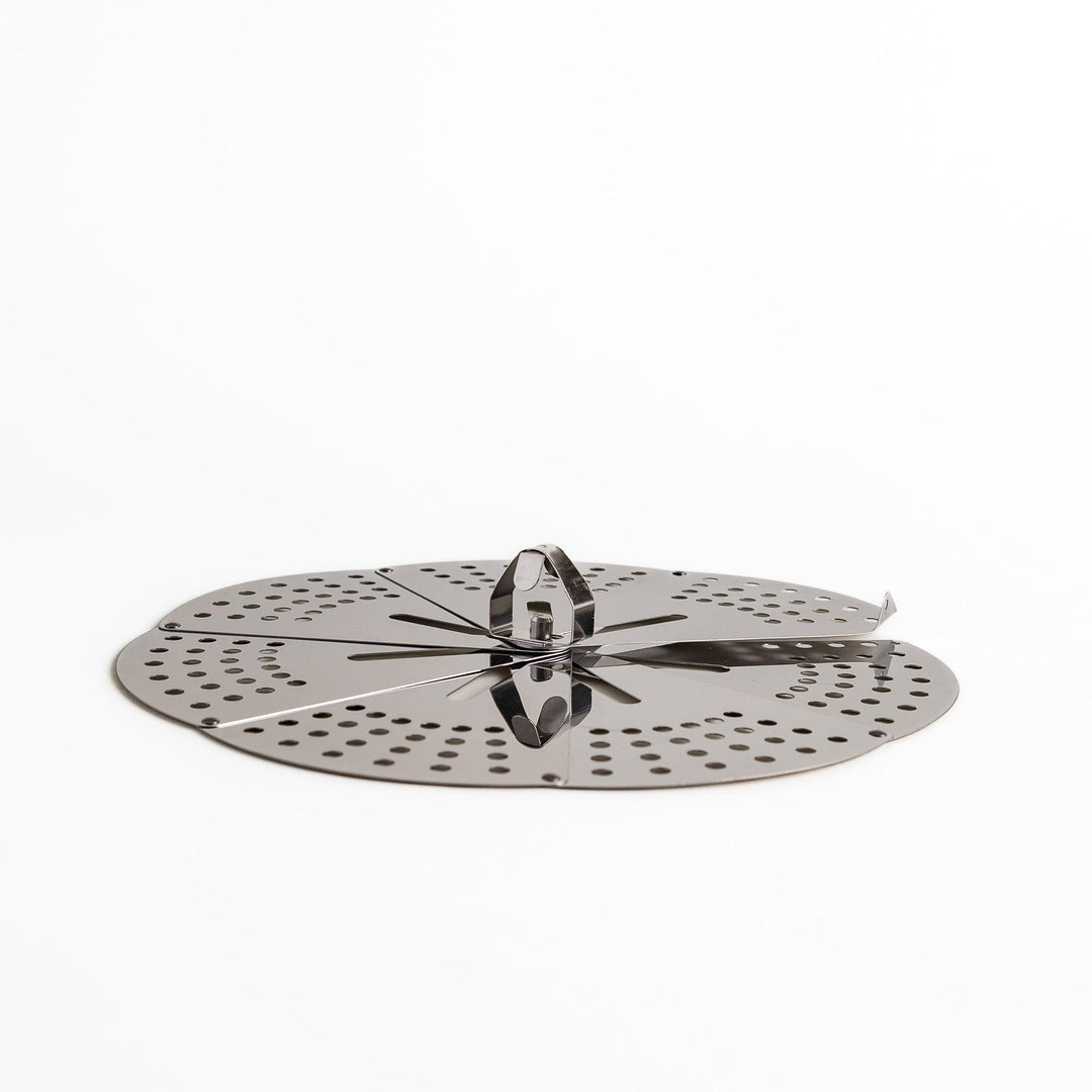 Adjustable stainless steel drop lid, a versatile kitchenware tool with foldable petals for steaming, simmering, and preventing boil-overs in various pot sizes.